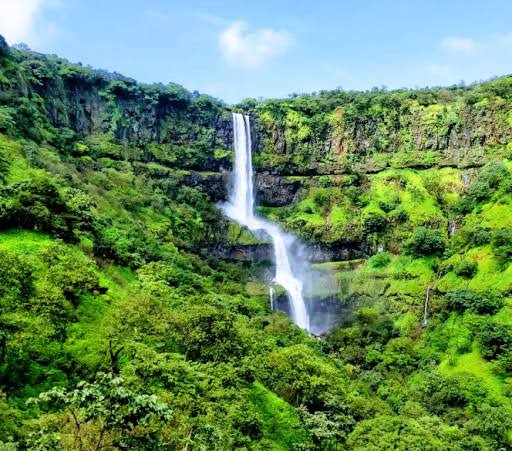 Vajrai Waterfall cascading through green cliffs